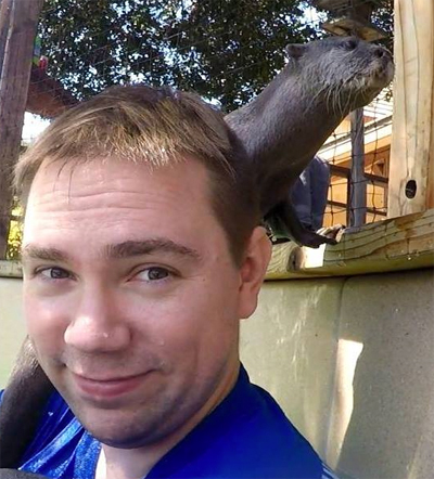 Andrew Whitesell with an otter on his shoulder.
