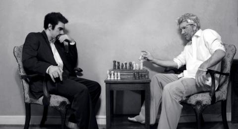 Image of a evil person and a saintly person playing chess.