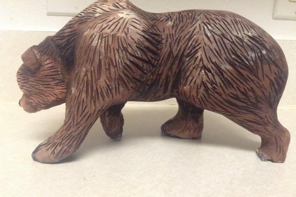 wooden carving of a grizzly bear