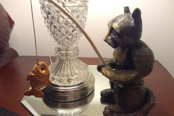 Wooden cat fishing for gold fish.