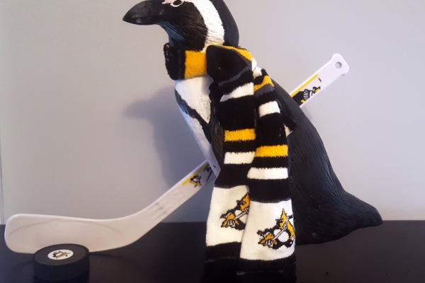 near life size carving of an African penguin